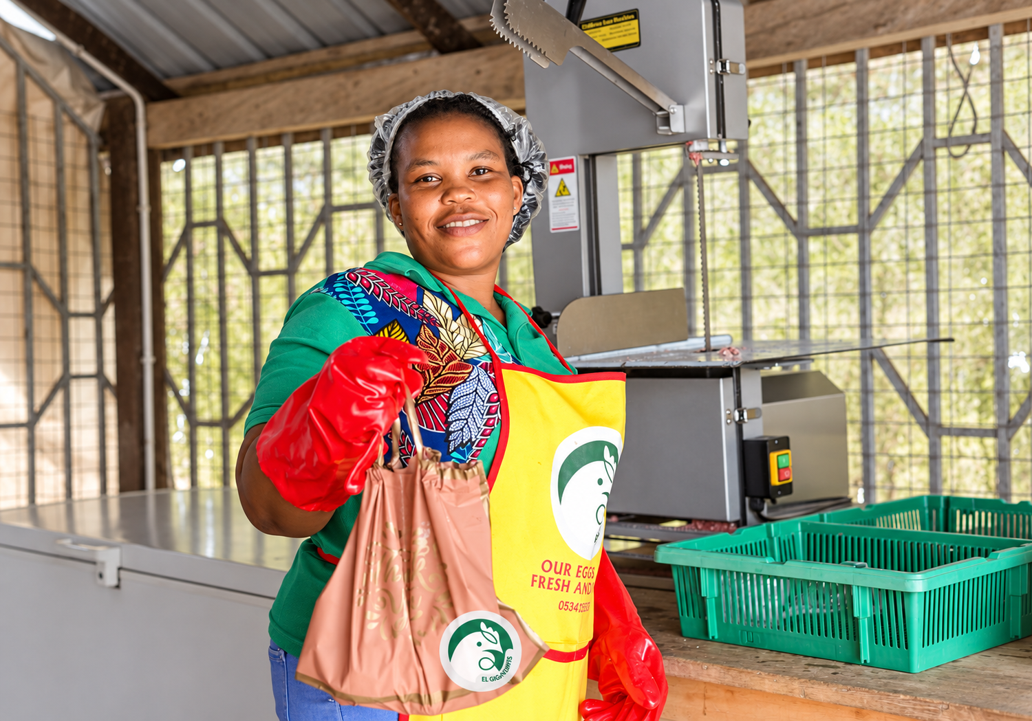 EL Giga Farms team member with packaged poultry products inside the processing area